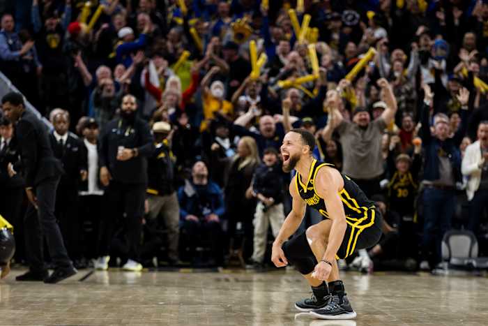 Golden State Warriors guard Stephen Curry celebrates a game-winning shot against the Phoenix Suns.